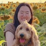 Headshot of Dr. Rong Cai with her blonde dog in a field of sunflowers