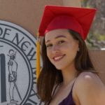 Headshot of Carol De Groote Tavares in a red graduation cap